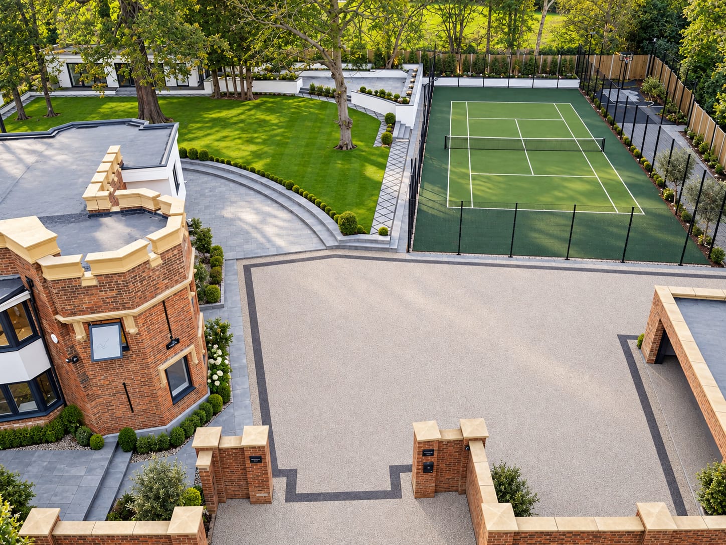 Aerial view of an open resin courtyard beside a tennis court